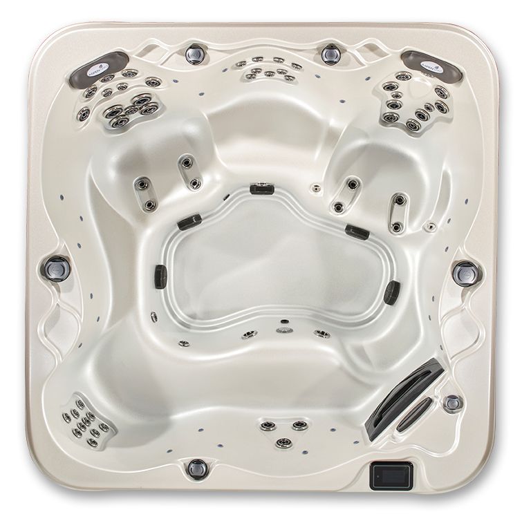 Top-down view of an empty, square, off-white hot tub with multiple molded seats and various jet configurations.