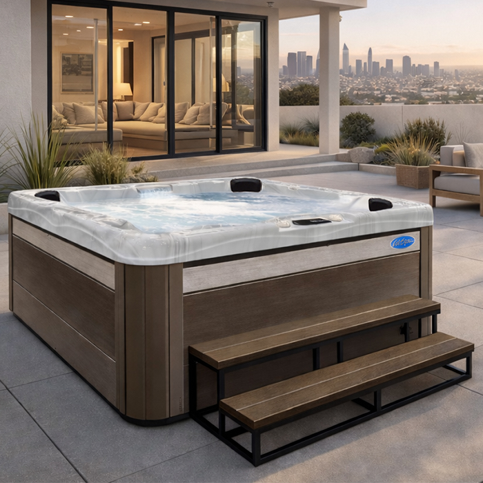 Modern outdoor hot tub on a rooftop terrace with city skyline view and lounge seating
