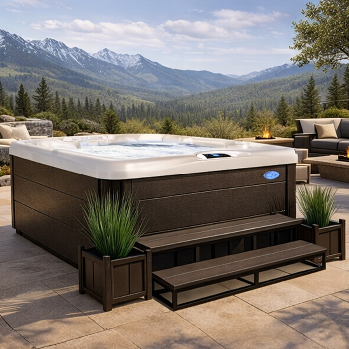 Brown outdoor hot tub on a patio with mountain views and lounge seating