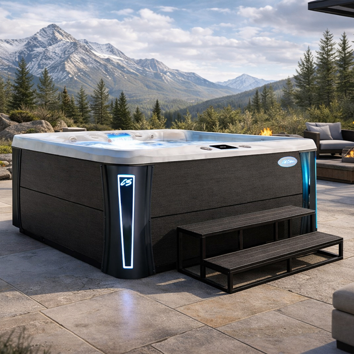 Modern hot tub on a patio with mountain views and evergreens in the background