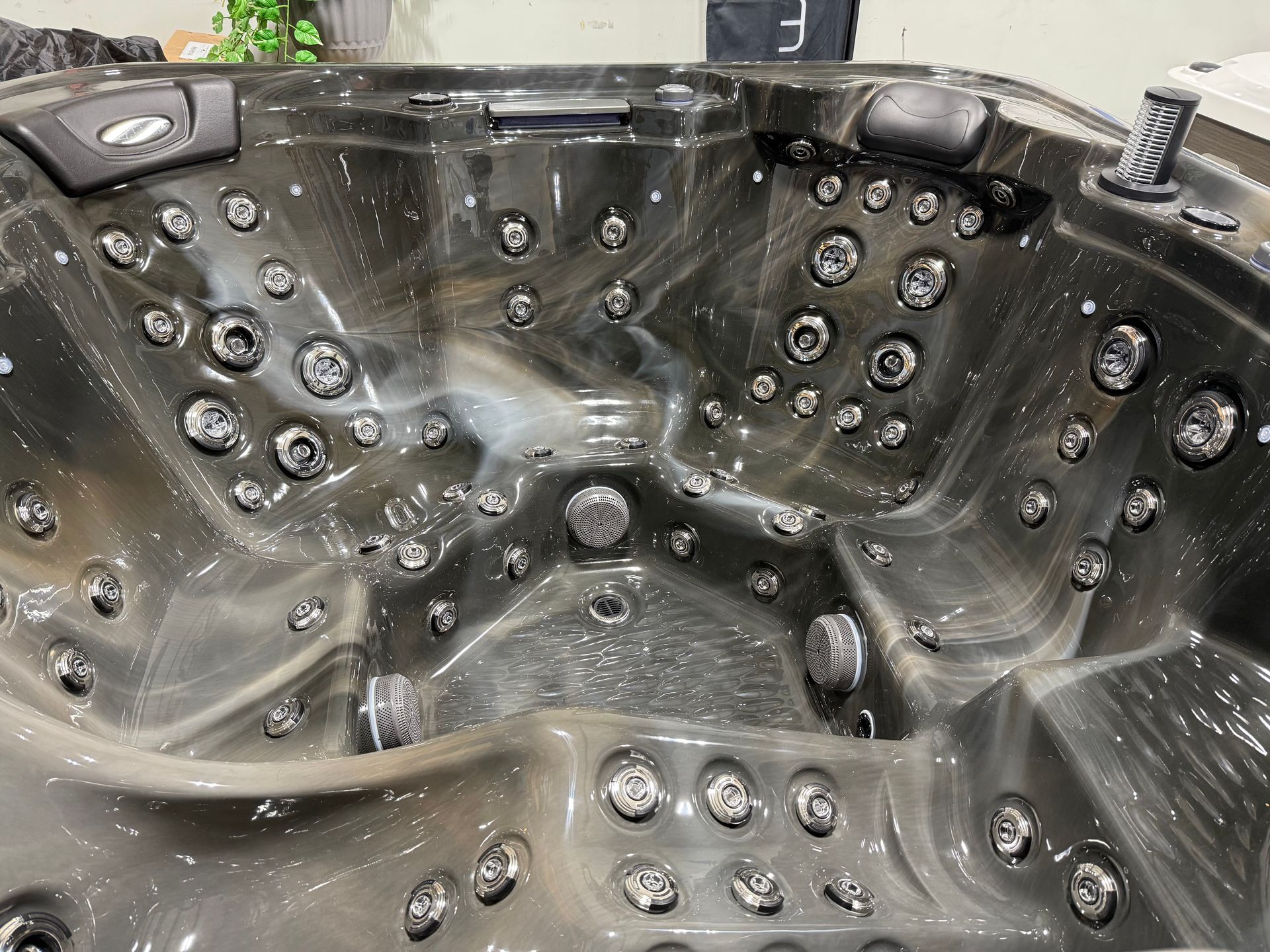 Dark gray hot tub interior with multiple jet nozzles.