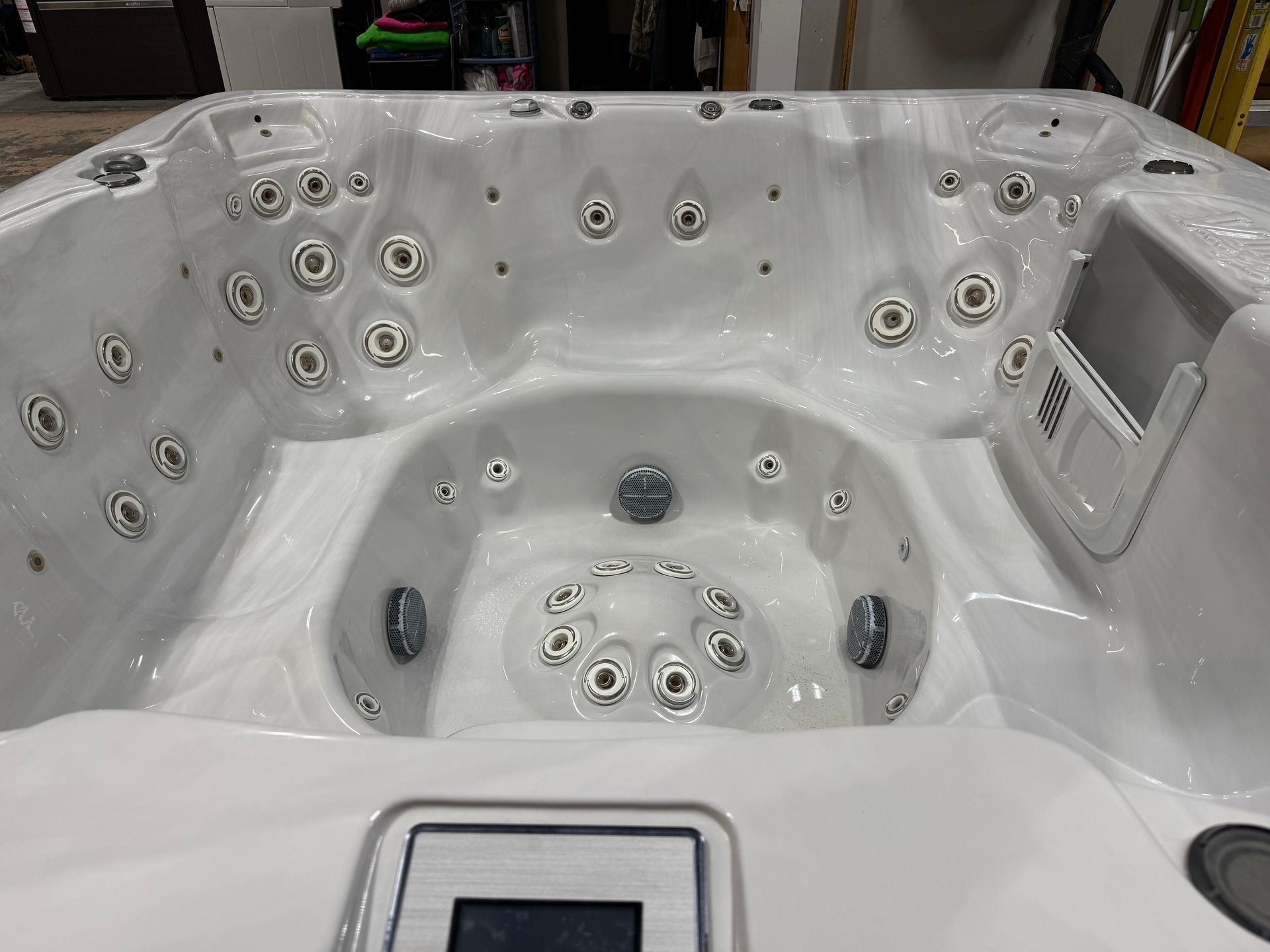 White hot tub interior with numerous jets.