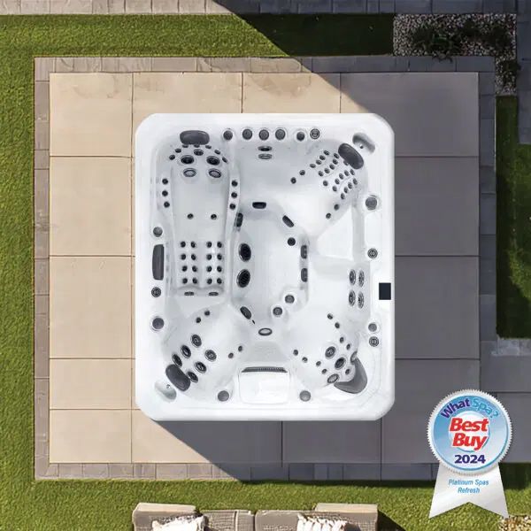An overhead view of a white rectangular hot tub on a stone patio, featuring a Best Buy 2024 award badge.