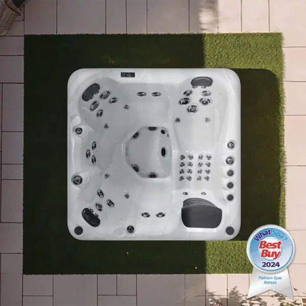 An overhead view of a square white hot tub on a square of artificial grass, with a 2024 Best Buy award icon in the corner.
