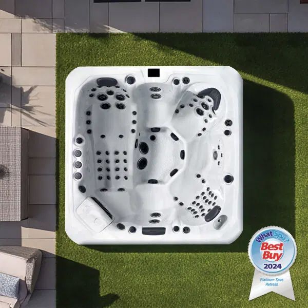 A white hot tub sits on a lawn next to a patio, with a Best Buy 2024 award badge in the corner.