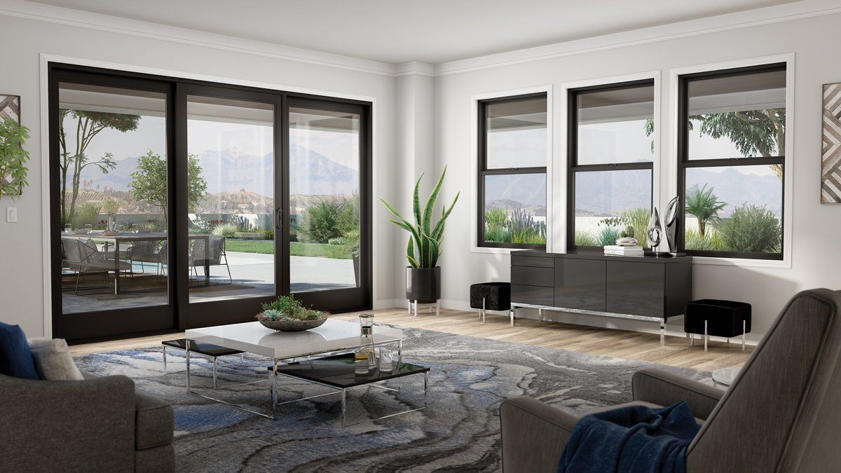 A living room with a lot of windows and sliding glass doors.