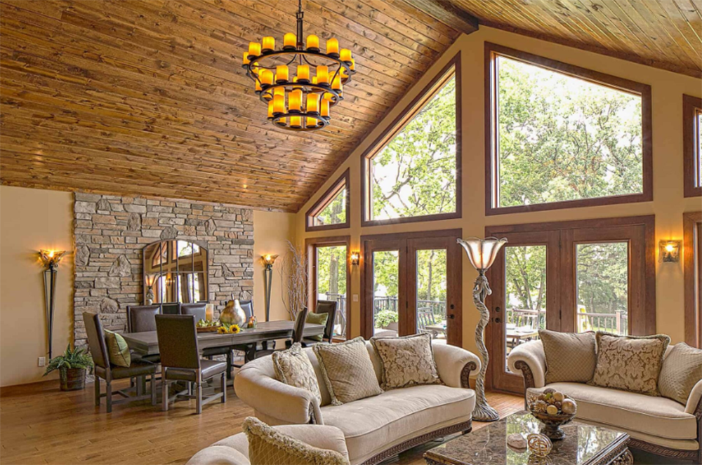 A living room with a vaulted ceiling and lots of windows