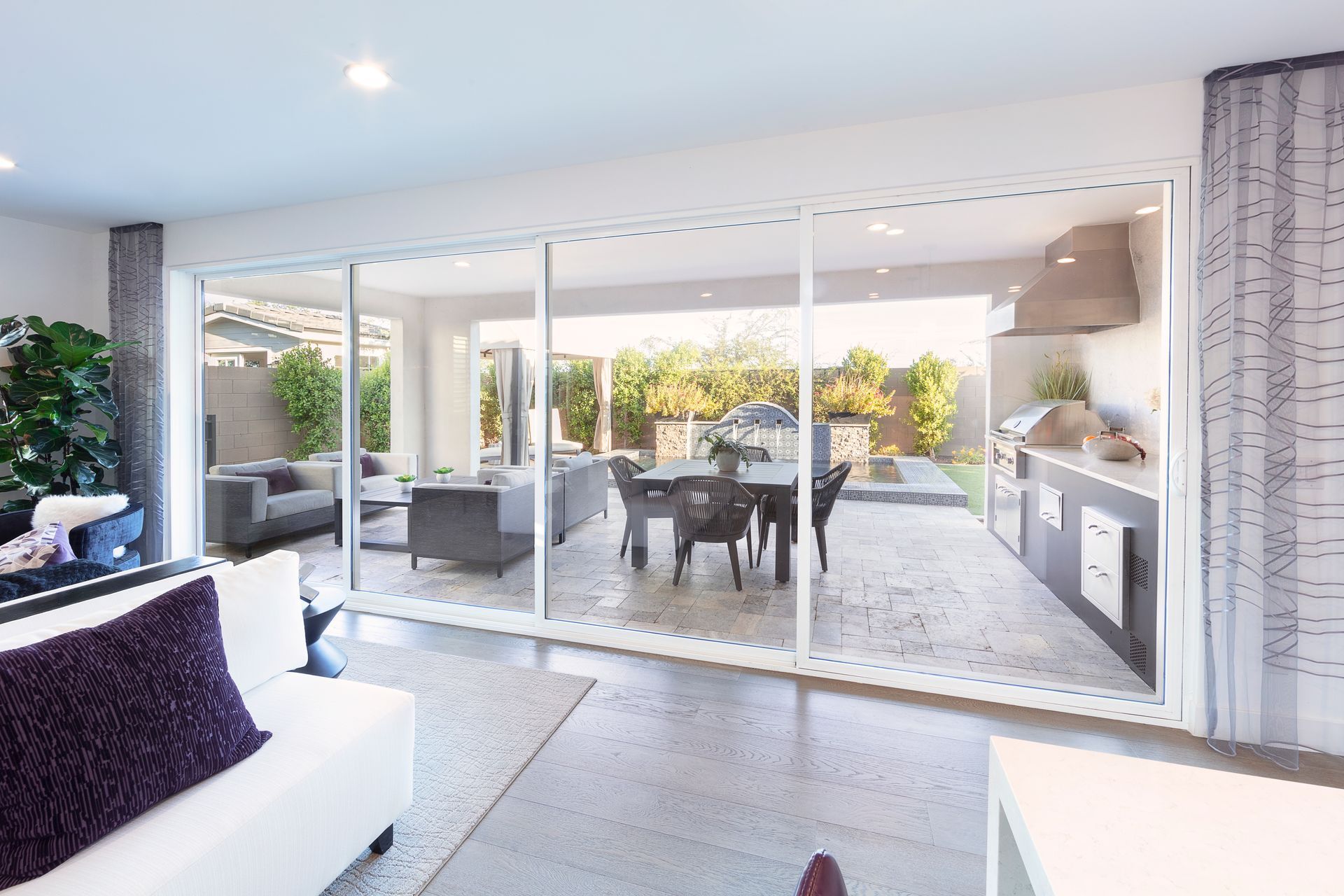A living room with sliding glass doors leading to a patio