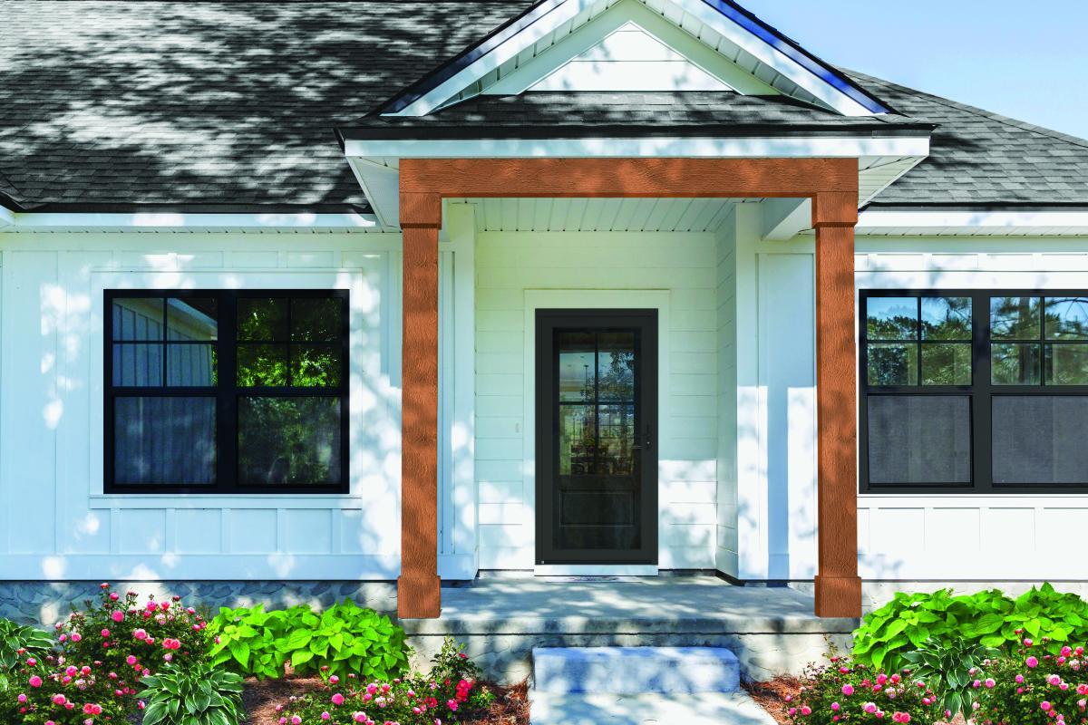 A white house with black windows and a black door.