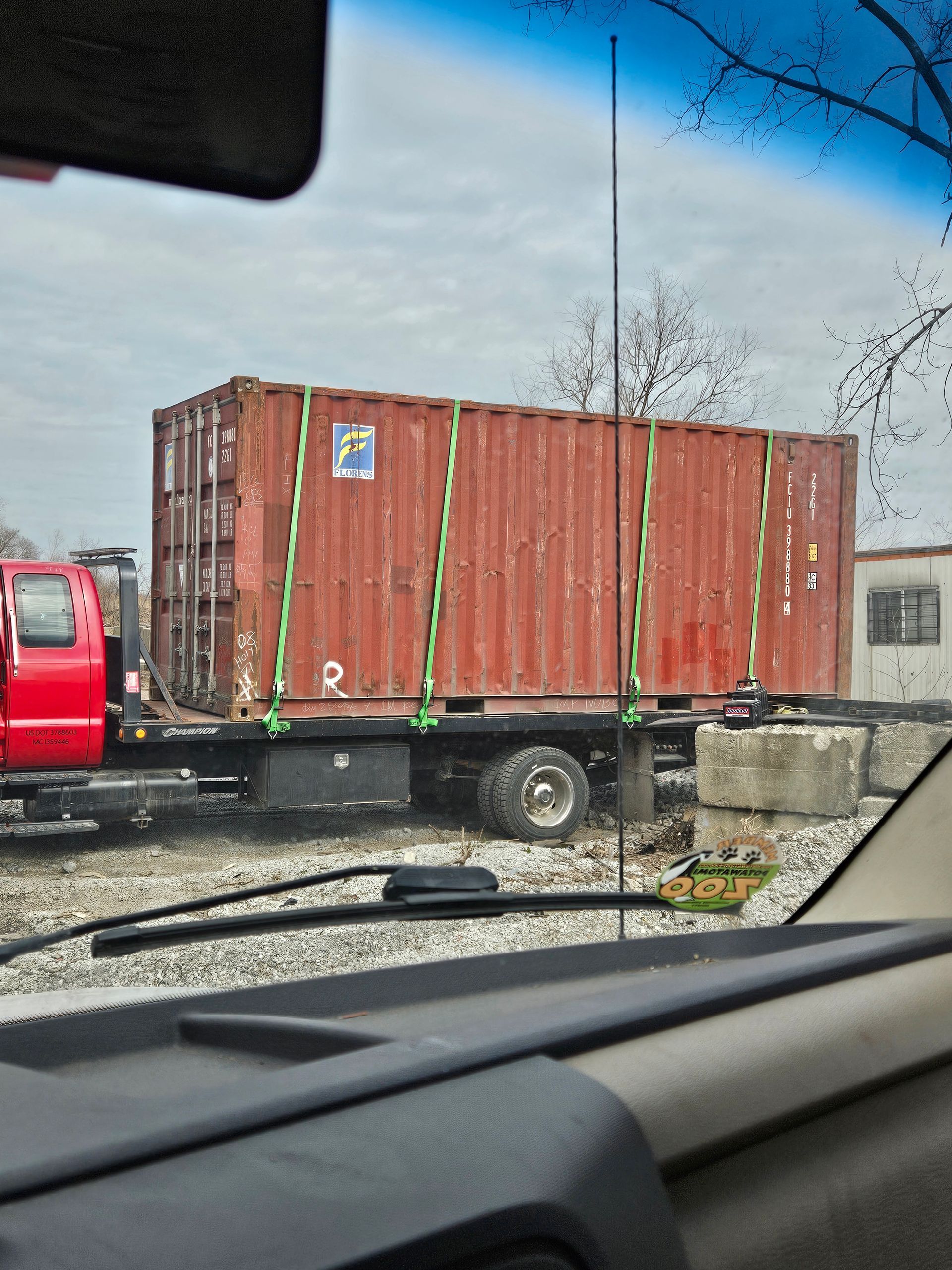 A large red shipping container with the letter h on it