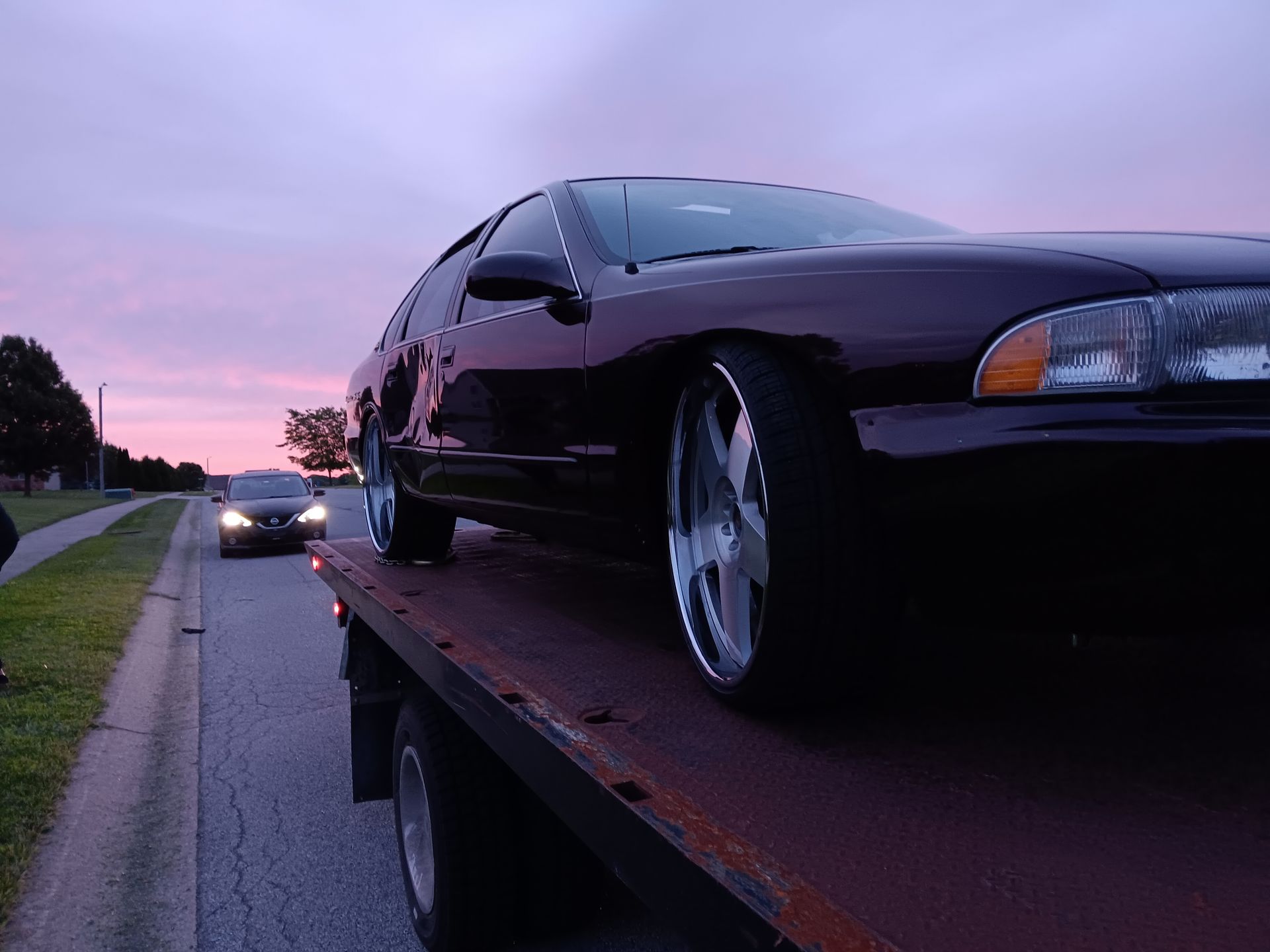A car is being towed by a tow truck