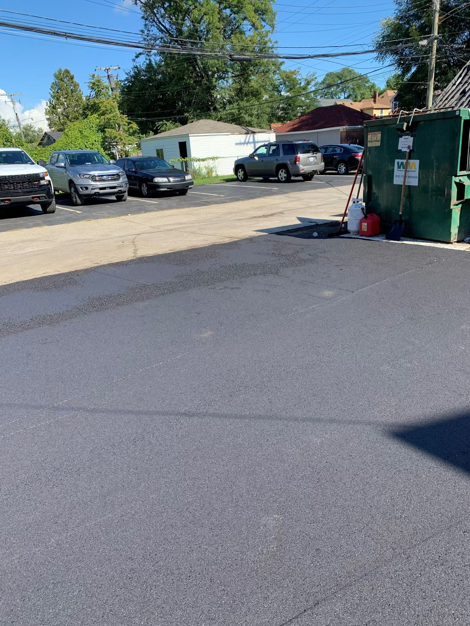 A row of cars are parked in a parking lot.