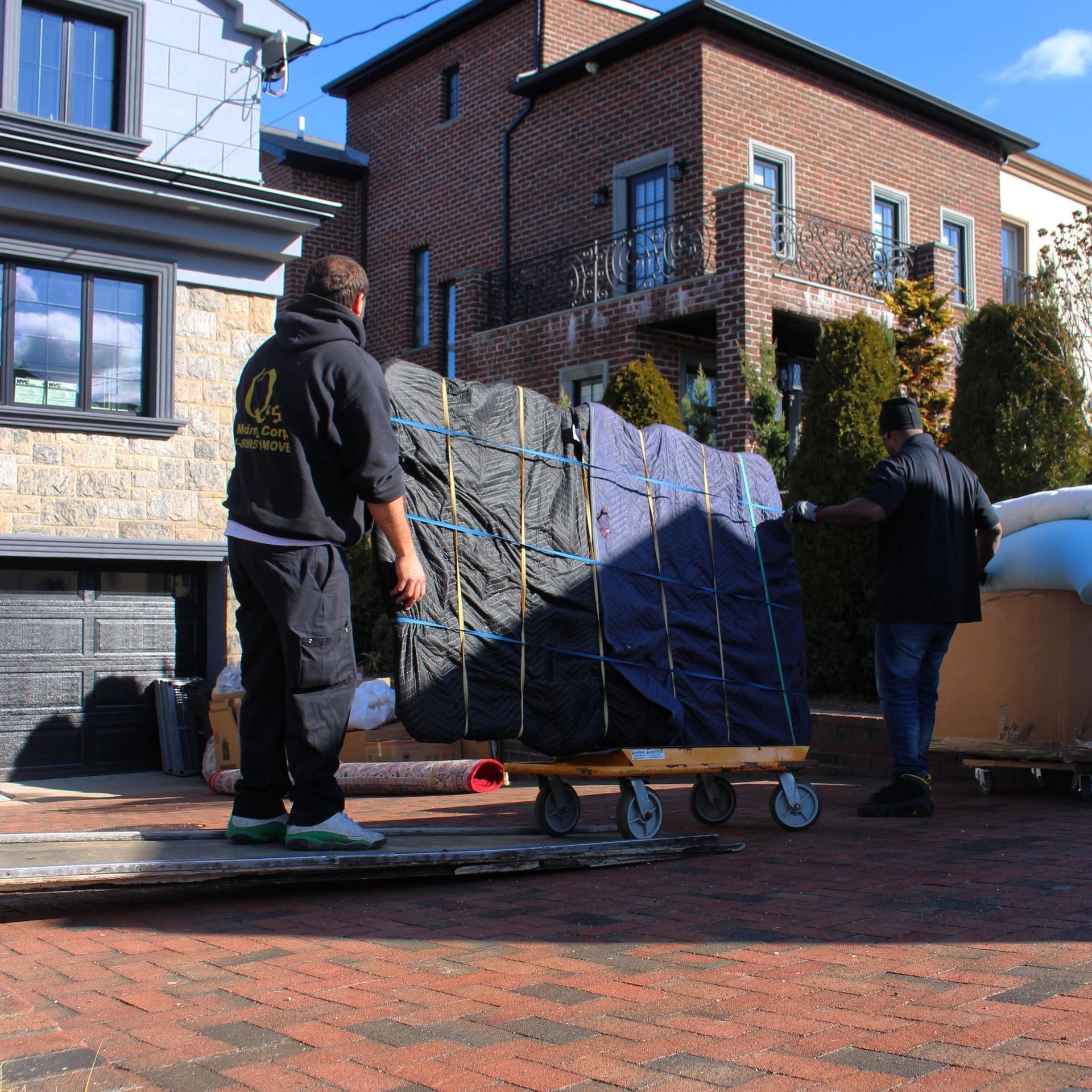 A man wearing a black hoodie with the letter l on it