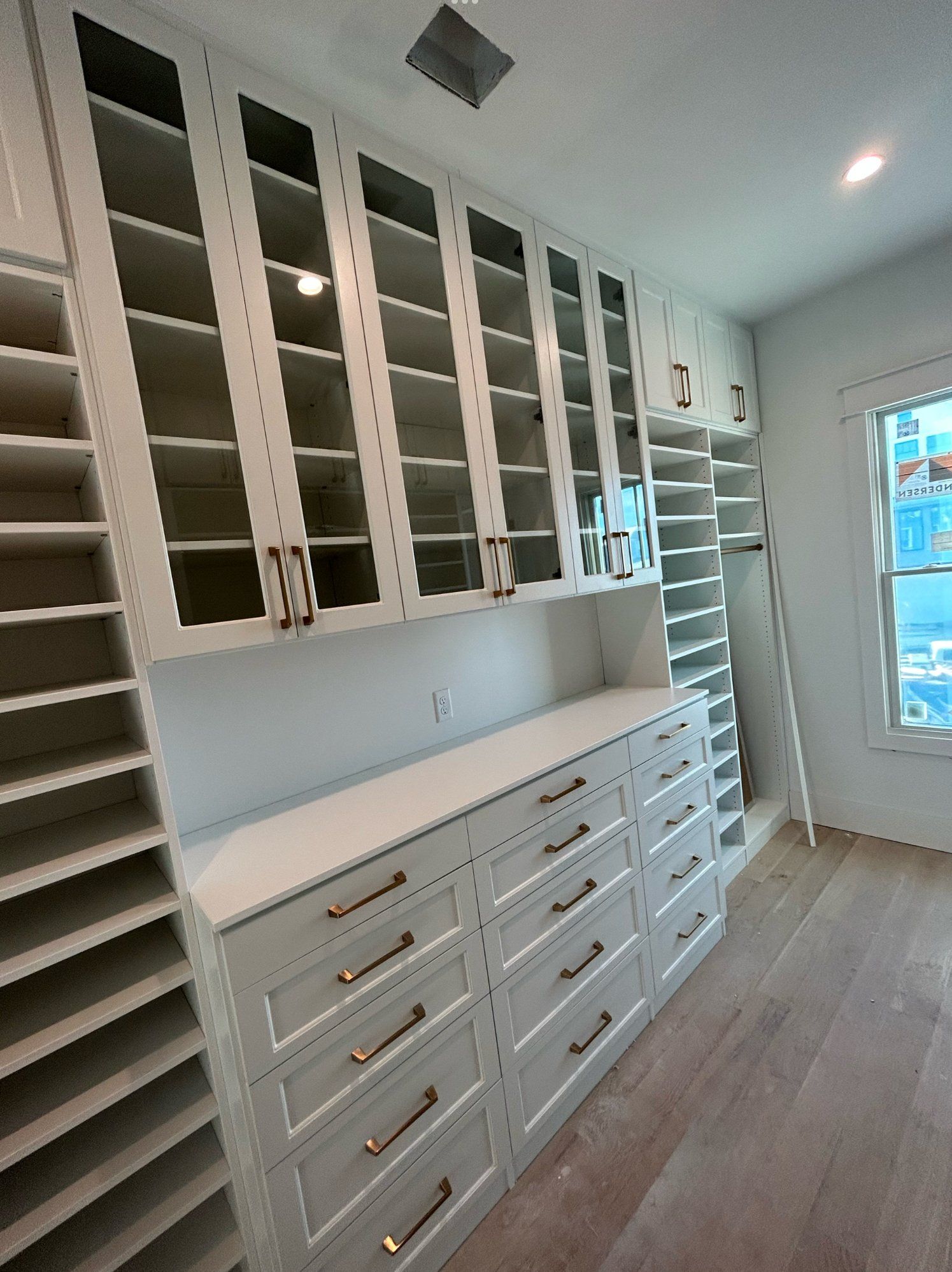 A walk in closet with lots of drawers and shelves