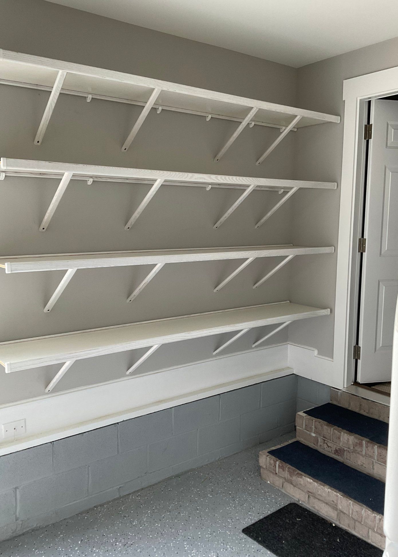 A room with a lot of shelves and stairs.