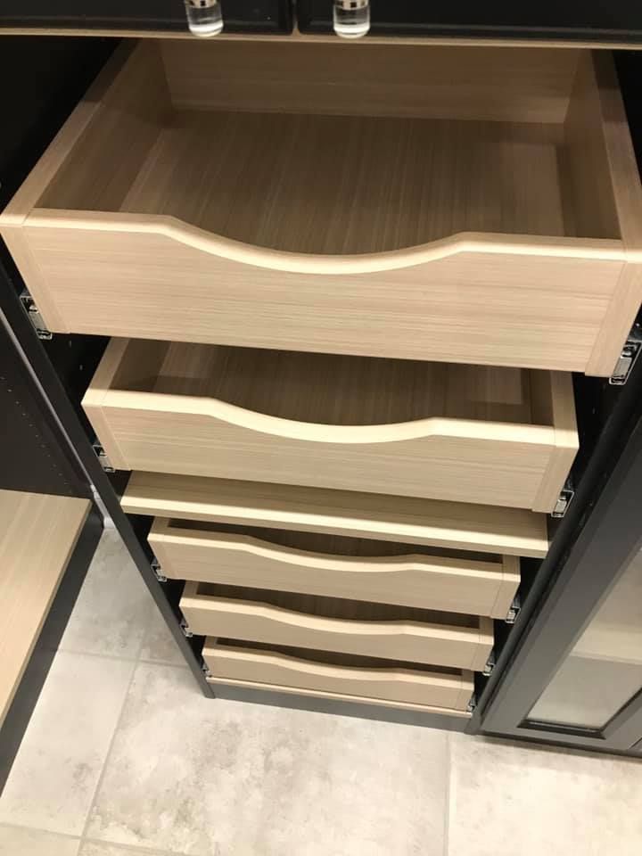 The drawers are made of wood and are stacked on top of each other.