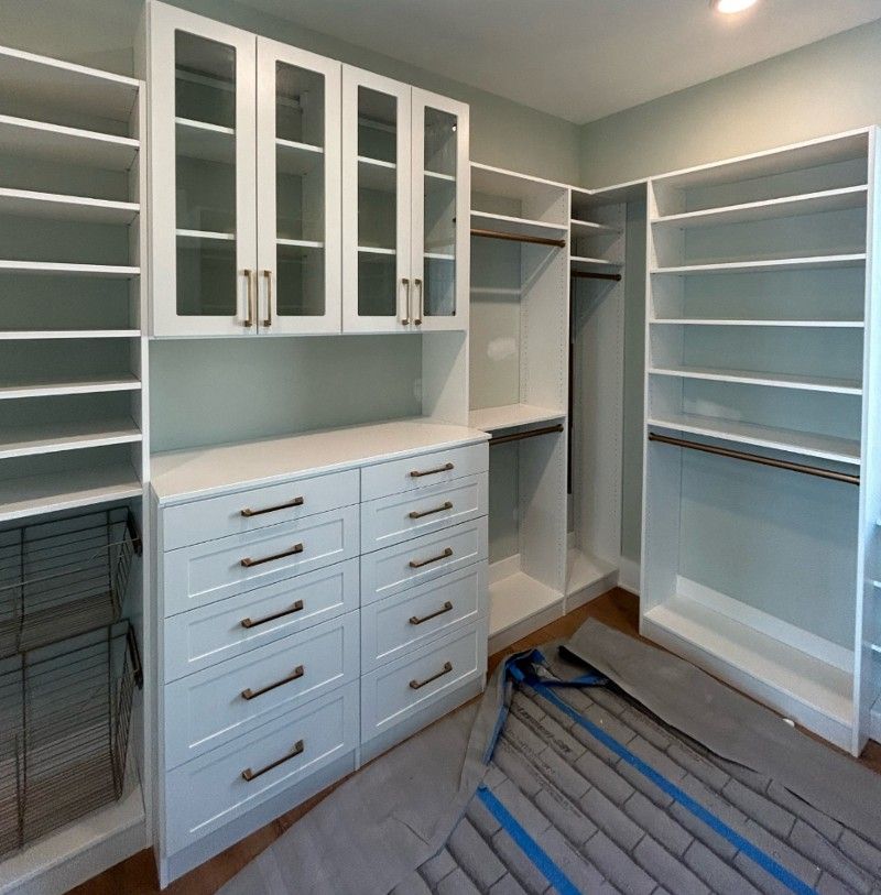 A walk in closet with lots of drawers and shelves.