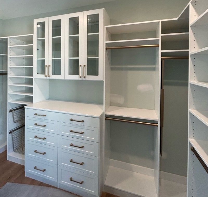 A walk in closet with lots of drawers and shelves