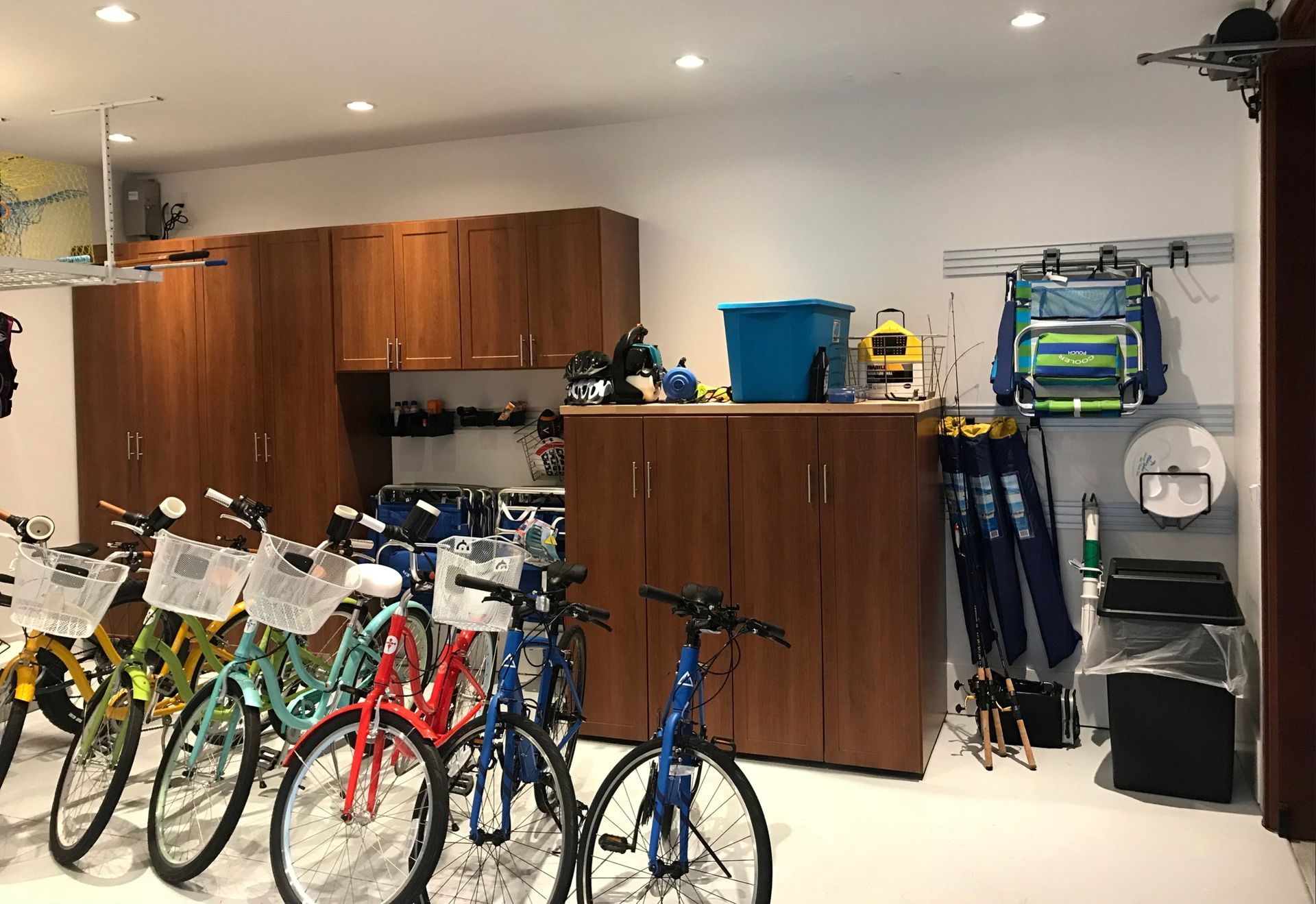 A row of bicycles are parked in a garage.