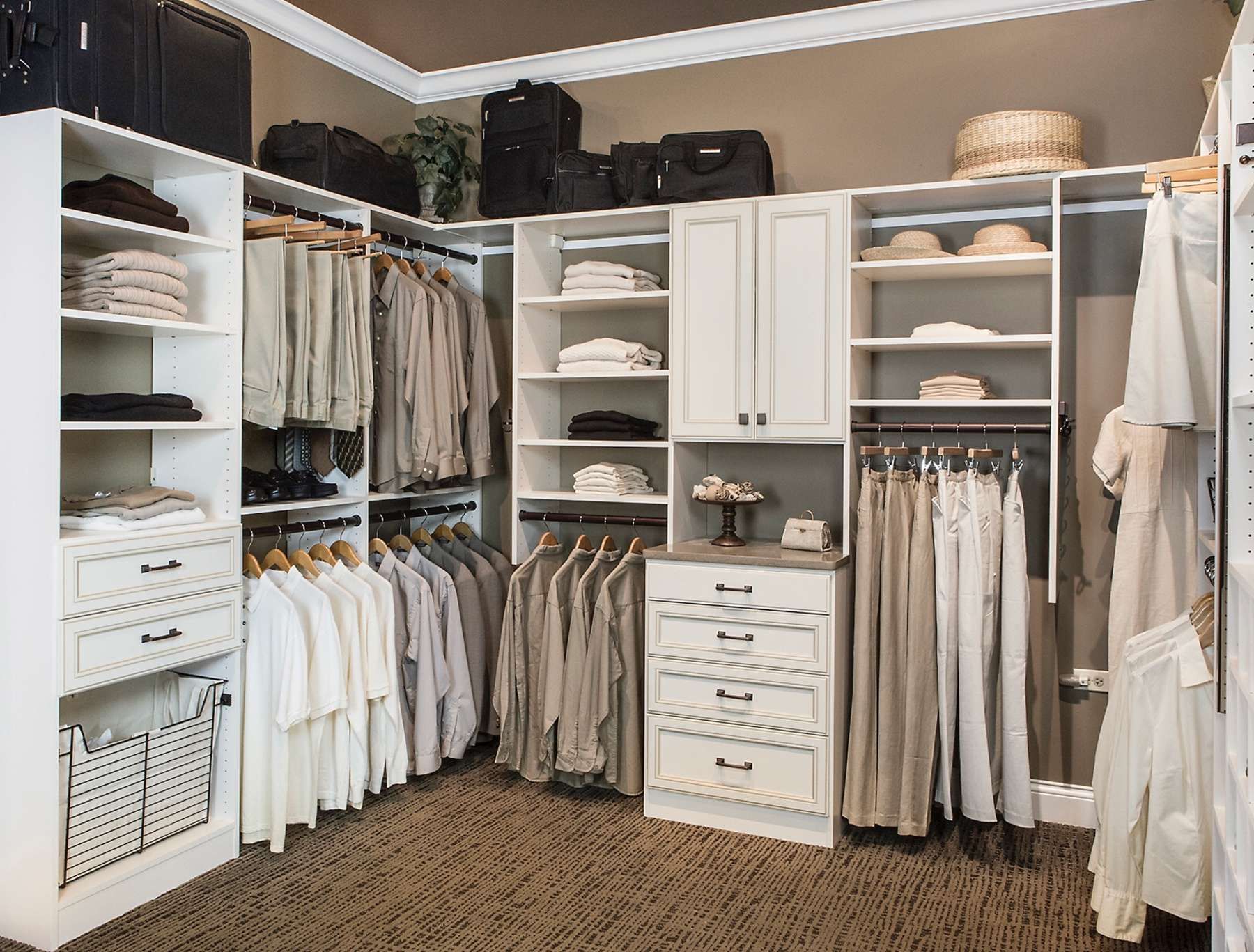 A walk in closet filled with lots of clothes and luggage.