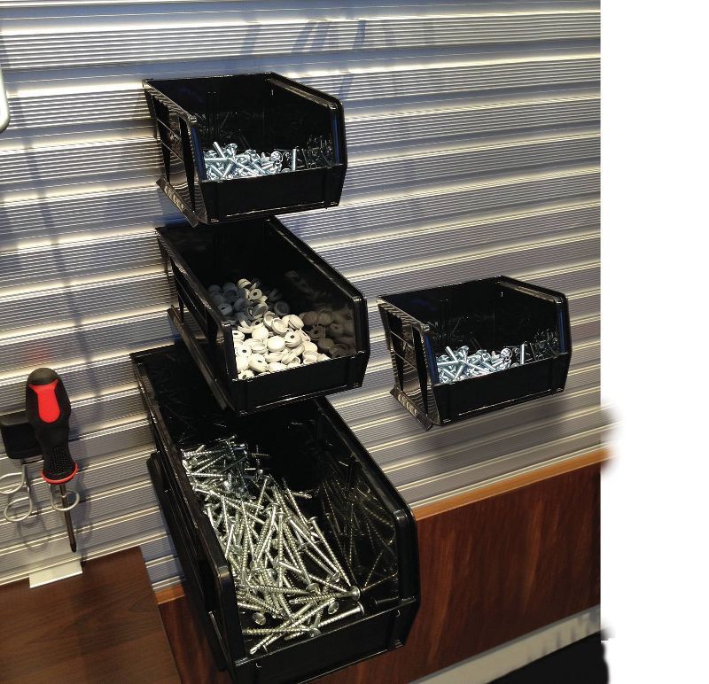 A stack of black bins filled with screws and nails
