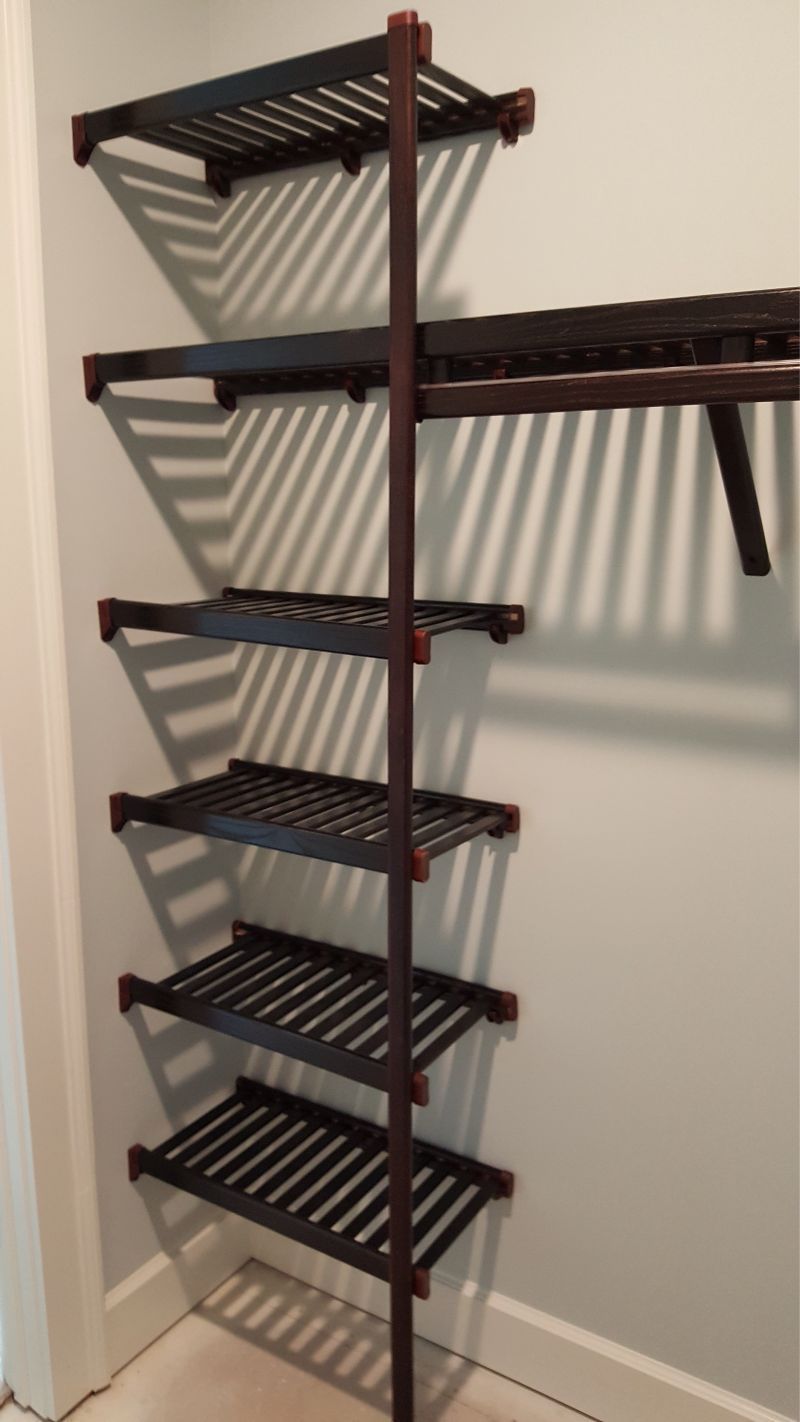 A closet with a row of shelves and a hanging rack
