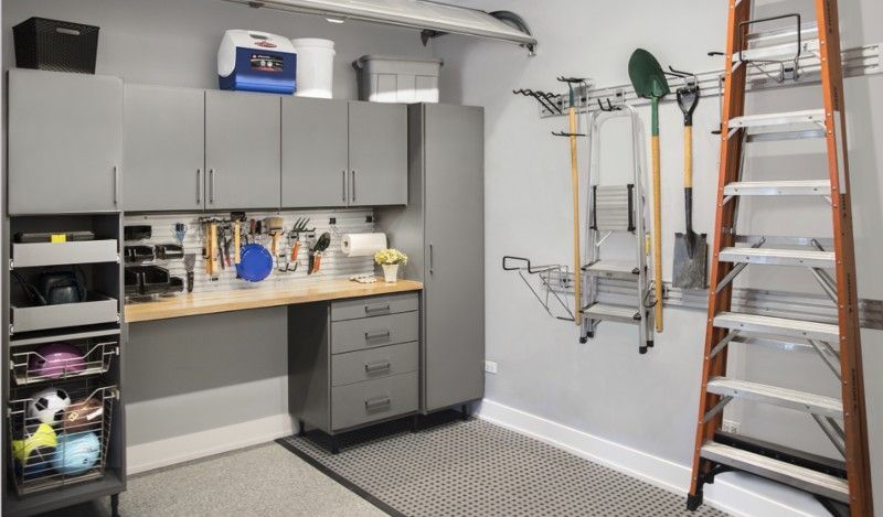 A garage filled with lots of storage space and a ladder.