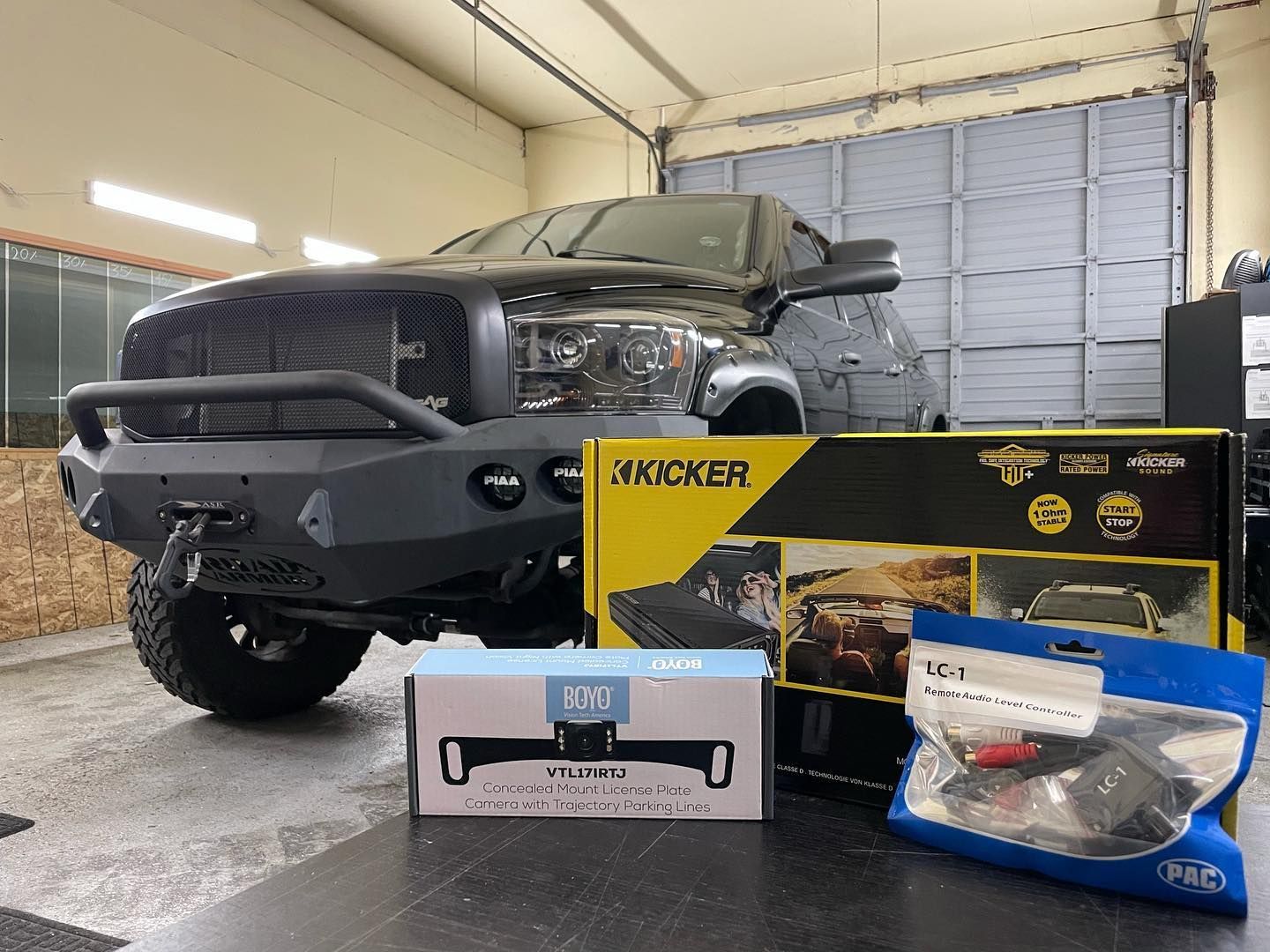 a truck is parked in a garage next to boxes of accessories .