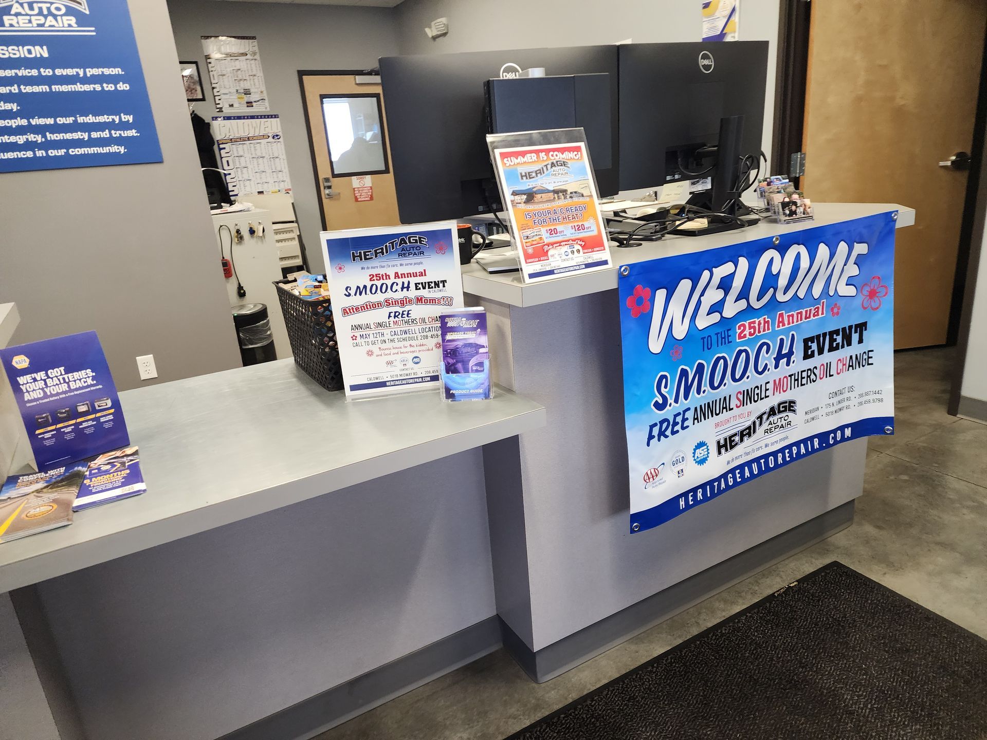 Front desk counter with a blue welcome sign and brochures in a clinic lobby.