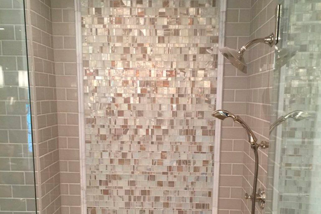 shower with a tile glass accent wall
