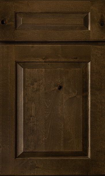A close up of a brown wooden cabinet door.