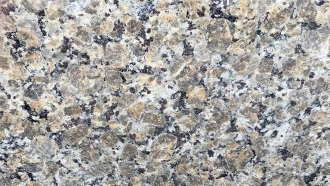 A close up of a granite counter top showing the texture of the stone.