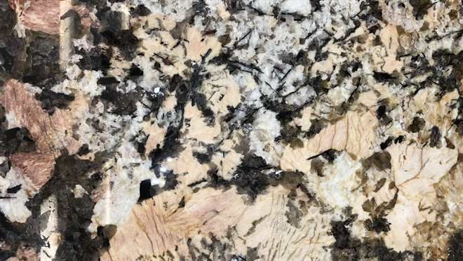 A close up of a granite counter top with a floral pattern.