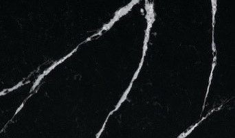 A close up of a black marble counter top with white veins.