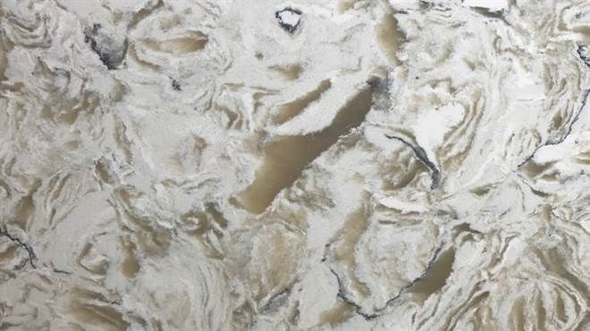 A close up of a white and brown marble counter top.