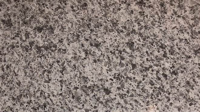 A close up of a gray granite counter top.