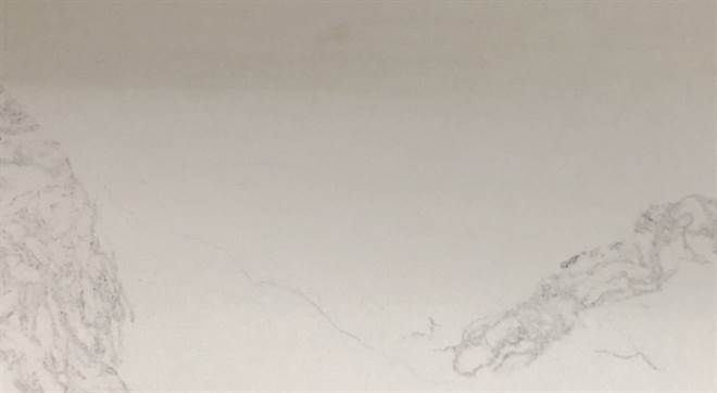 A close up of a white marble counter top.
