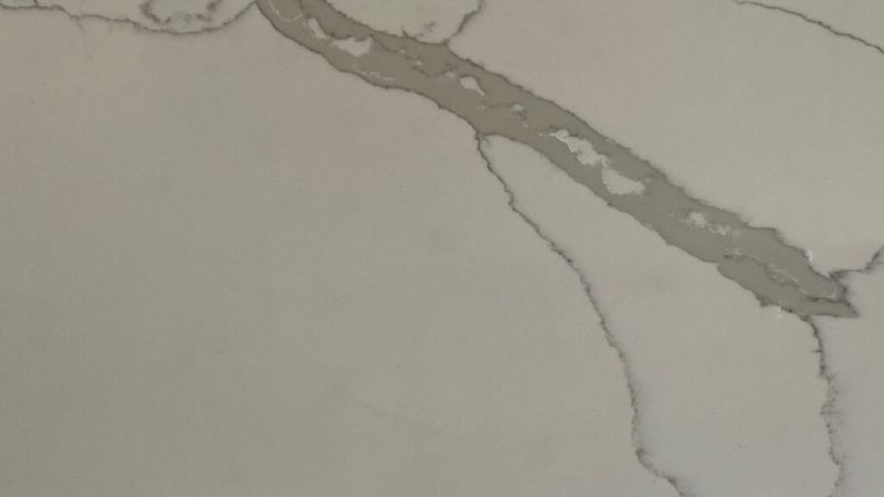 A close up of a white granite counter top with a marble texture.