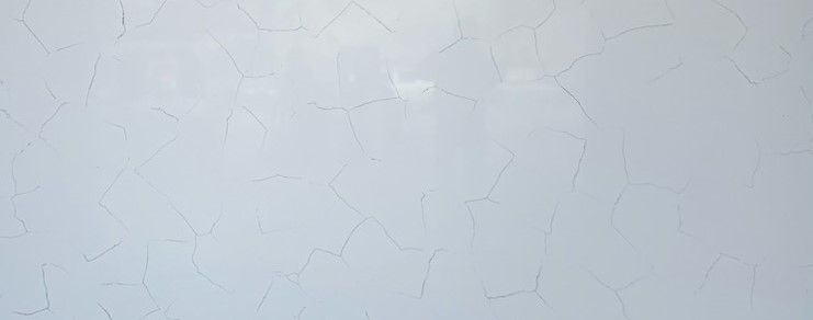 A close up of a white wall with a marble texture.
