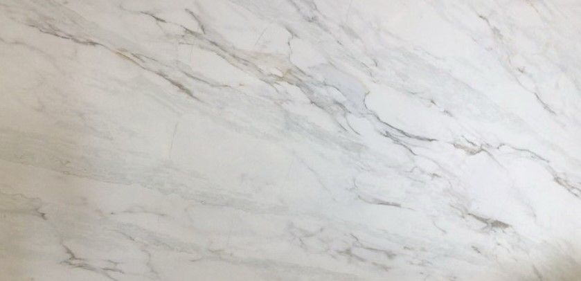 A close up of a white marble counter top.