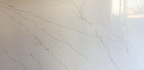 A close up of a white marble counter top.