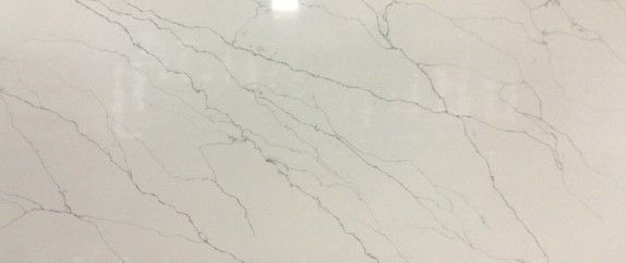 A close up of a white marble counter top.