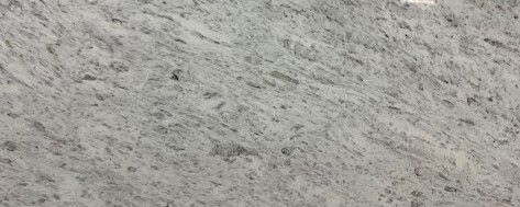 A close up of a white granite counter top.