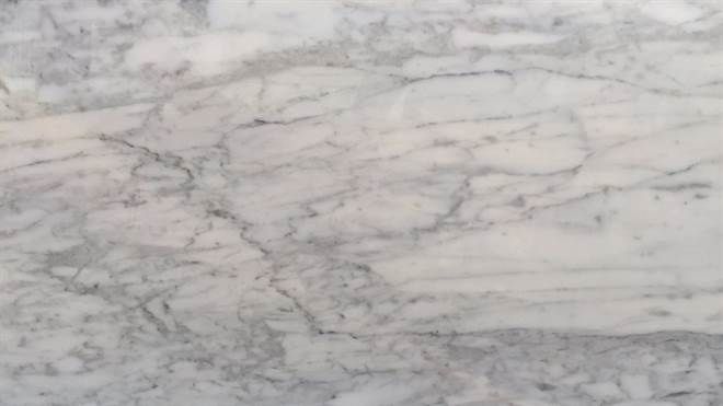 A close up of a white marble counter top.
