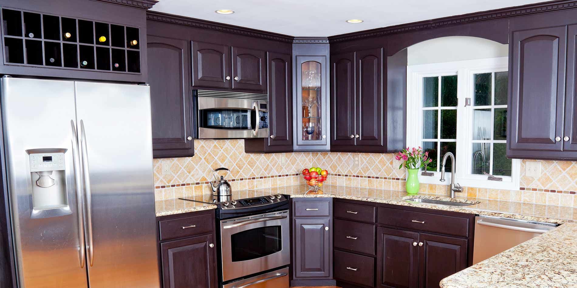 A kitchen with purple cabinets and stainless steel appliances