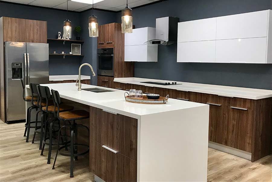 A kitchen with stainless steel appliances , wooden cabinets , and a large island.