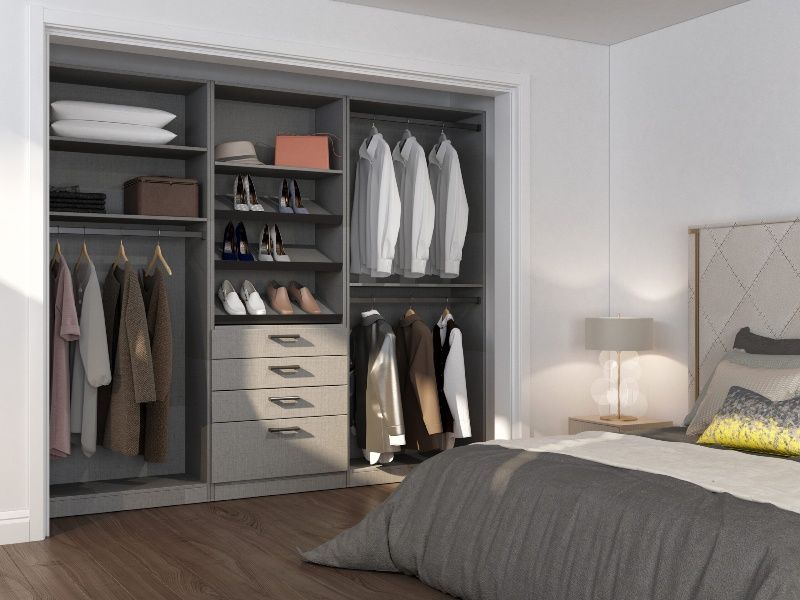 A bedroom with a walk in closet and a bed
