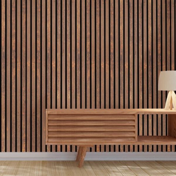 A living room with a wooden cabinet , lamp , and striped wall.