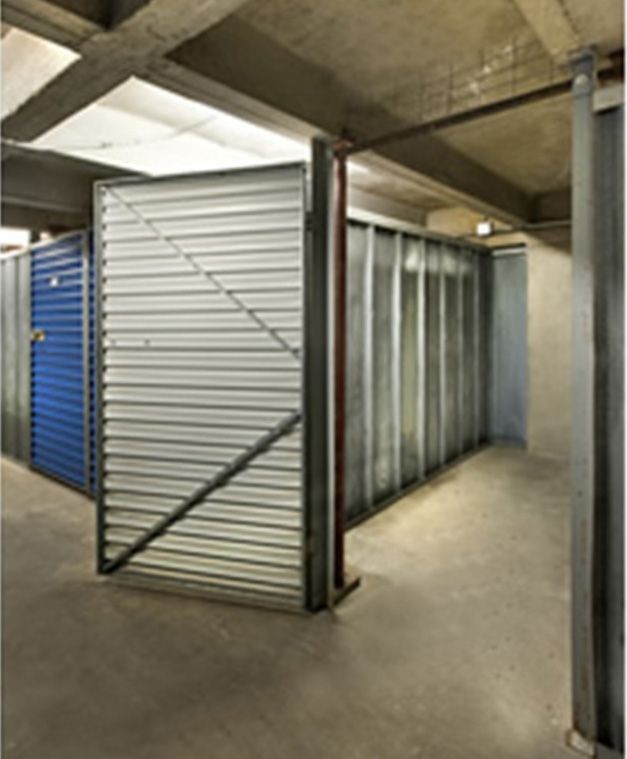 A warehouse with a blue door and a white door