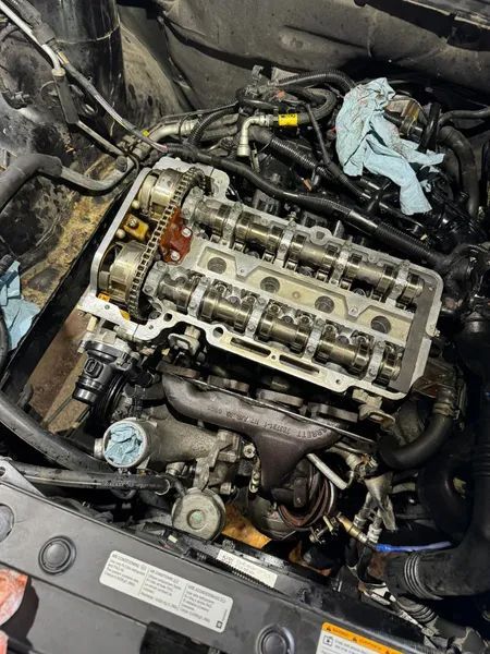 A close up of a car engine with the hood open.